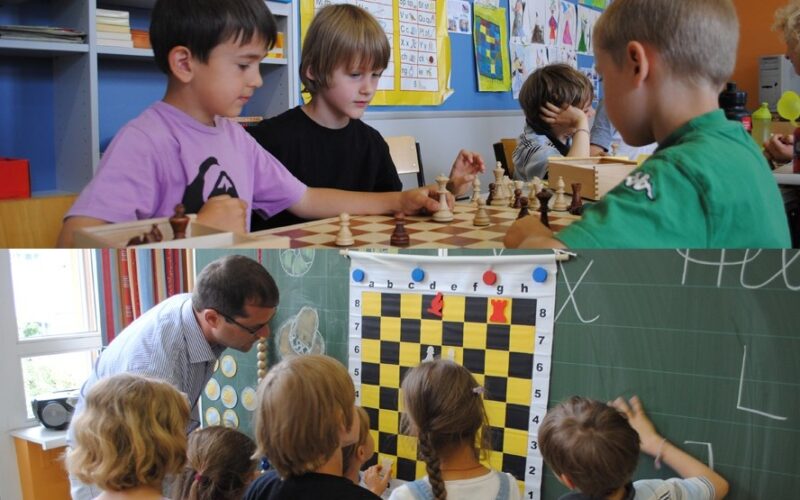 Kinder spielen Schach an einem Tisch in einem Klassenzimmer, während eine andere Gruppe von Kindern unter Anleitung eines Erwachsenen an einem Demonstrationsbrett etwas über Schach lernt.