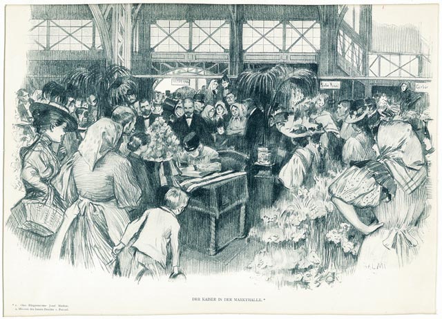 Eine belebte Szene in einem Innenraum zeigt Menschen, die sich um einen Mann an einem Tisch versammelt haben, der Dokumente unterschreibt, während überall im Raum Topfpflanzen und Blumen aufgestellt sind.